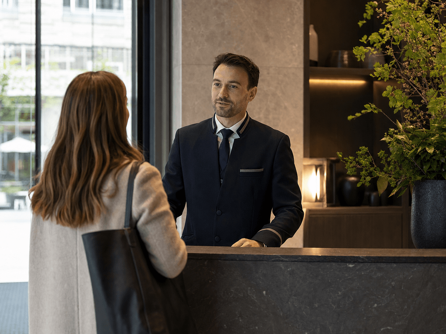 A Poscas team member coordinating support at a reception desk